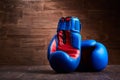 Boxing background with two gloves on the brown plank background. Royalty Free Stock Photo