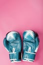 Boxing blue gloves on a pink background