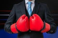 Boxing businessman with red gloves in box ring