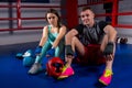 Boxing couple sitting near lying boxing gloves and helmet Royalty Free Stock Photo