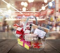 Boxing day. Shopping basket with gifts in supermarket Royalty Free Stock Photo