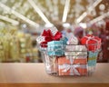 Boxing day. Shopping basket with gifts in supermarket Royalty Free Stock Photo