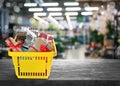 Boxing day. Shopping basket with gifts in supermarket, space for text Royalty Free Stock Photo