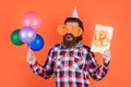 boxing day. happy birthday to you. male holiday celebration. bearded guy with party balloons and gift box. unshaven Royalty Free Stock Photo