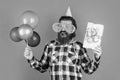 boxing day. happy birthday to you. male holiday celebration. bearded guy with party balloons and gift box. unshaven Royalty Free Stock Photo