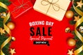 Boxing day sale with Christmas present and xmas decoration on red background Royalty Free Stock Photo