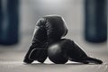 Boxing gloves on the floor of a gym after exercise, training and workout. Pair of sport handwear or equipment on the