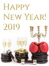 Boxing gloves and glasses of champagne on weight plates and dumbbells. Concept for new years resolution 2019 and workout