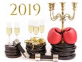 Boxing gloves and glasses of champagne on weight plates and dumbbells. Concept for new years resolution 2019 and workout
