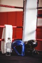 Boxing gloves, headgear, water bottle and a towel in boxing ring Royalty Free Stock Photo
