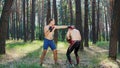 In boxing gloves, young athletic men with bare, naked torsos, box, practice the technique of strikes, capture, fight