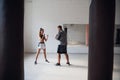 In the boxing hall, an experienced trainer teaches a young girl the correct stance Royalty Free Stock Photo