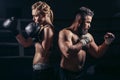 Boxing lessons concept. woman and man hold hands up in boxing gloves