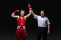Boxing referee gives medal to young boxer