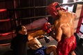 Boxing referee intervene, halting the fight to check fallen competitor. Impetus