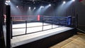 Boxing Ring with Red and Blue Ropes Under Dramatic Stage Lighting empty arena Royalty Free Stock Photo
