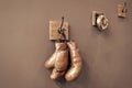 Boxing school. Final sparring. Vintage boxing gloves hang on hook wall background. Boxing gloves and ring bell. Boxing Royalty Free Stock Photo