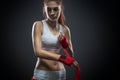 Boxing woman binds the bandage on his hand, before training, detail photo