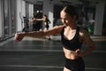 Boxing woman during exercise-gray background at gym Royalty Free Stock Photo