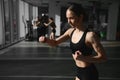 Boxing woman during exercise-gray background at gym Royalty Free Stock Photo