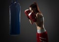 Boxing woman exercises with punching bag Royalty Free Stock Photo