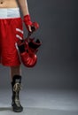 Boxing woman standing in box dress, holding boxing gloves - half body photo Royalty Free Stock Photo