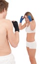 Boxing - Young woman in class training on white