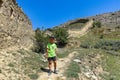 A boy against the background of the Gunib fortress. A protective wall. Russia, Dagestan. June 2021 Royalty Free Stock Photo