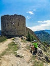 A boy against the background of the Gunib fortress. A protective wall. Russia, Dagestan. June 2021 Royalty Free Stock Photo