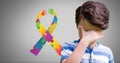 Boy against grey background with colorful spectrum hands ribbon Royalty Free Stock Photo