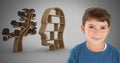 Boy against grey background smiling and head and tree bookshelf of knowledge