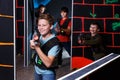 Boy aiming laser gun at other players during lasertag game Royalty Free Stock Photo