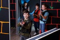 boy aiming laser gun at other players during lasertag game Royalty Free Stock Photo