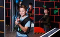 boy aiming laser gun at other players during lasertag game Royalty Free Stock Photo