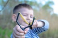 Boy Aiming Sling Shot at Camera Royalty Free Stock Photo