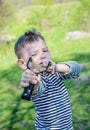 Boy Aiming Sling Shot at Camera Royalty Free Stock Photo
