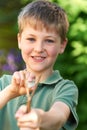 Boy Aiming Slingshot In Garden