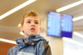 Boy in airport looking into distance Royalty Free Stock Photo