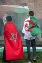 Boy with Algerian Flag on his Shoulders next to a Girl with Moroccan Flag on her Shoulders during a Political Demonstration