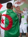 Boy with Algerian Flag on his Shoulders next to a Girl with Moroccan Flag on her Shoulders during a Political Demonstration