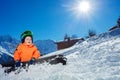 Boy on alpine ski track sit wear helmet ang mask over mountain Royalty Free Stock Photo