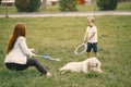 Boy amd his mother making a soap bubbles while playing with dog Royalty Free Stock Photo