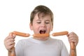 Boy with appetite bites sausages Royalty Free Stock Photo