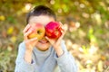 Children with Apple in Orchard. Harvest Concept