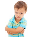 Boy, arms crossed and anger in studio portrait with mental health, anxiety and stress by white background. Child, sad Royalty Free Stock Photo