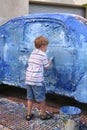 Boy artistically paints car Royalty Free Stock Photo