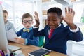 Boy as business executive laughing while looking at digital tablet Royalty Free Stock Photo