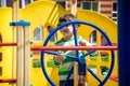 Boy as a captain or sailors play on the ship outdoors on sunny day. Kid has a lot of fun. Ship has colorful flags on wind Royalty Free Stock Photo