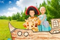 Boy as pirate holds helm and princess girl Royalty Free Stock Photo