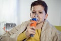 Boy with asthma problems making inhalation with mask on her face Royalty Free Stock Photo